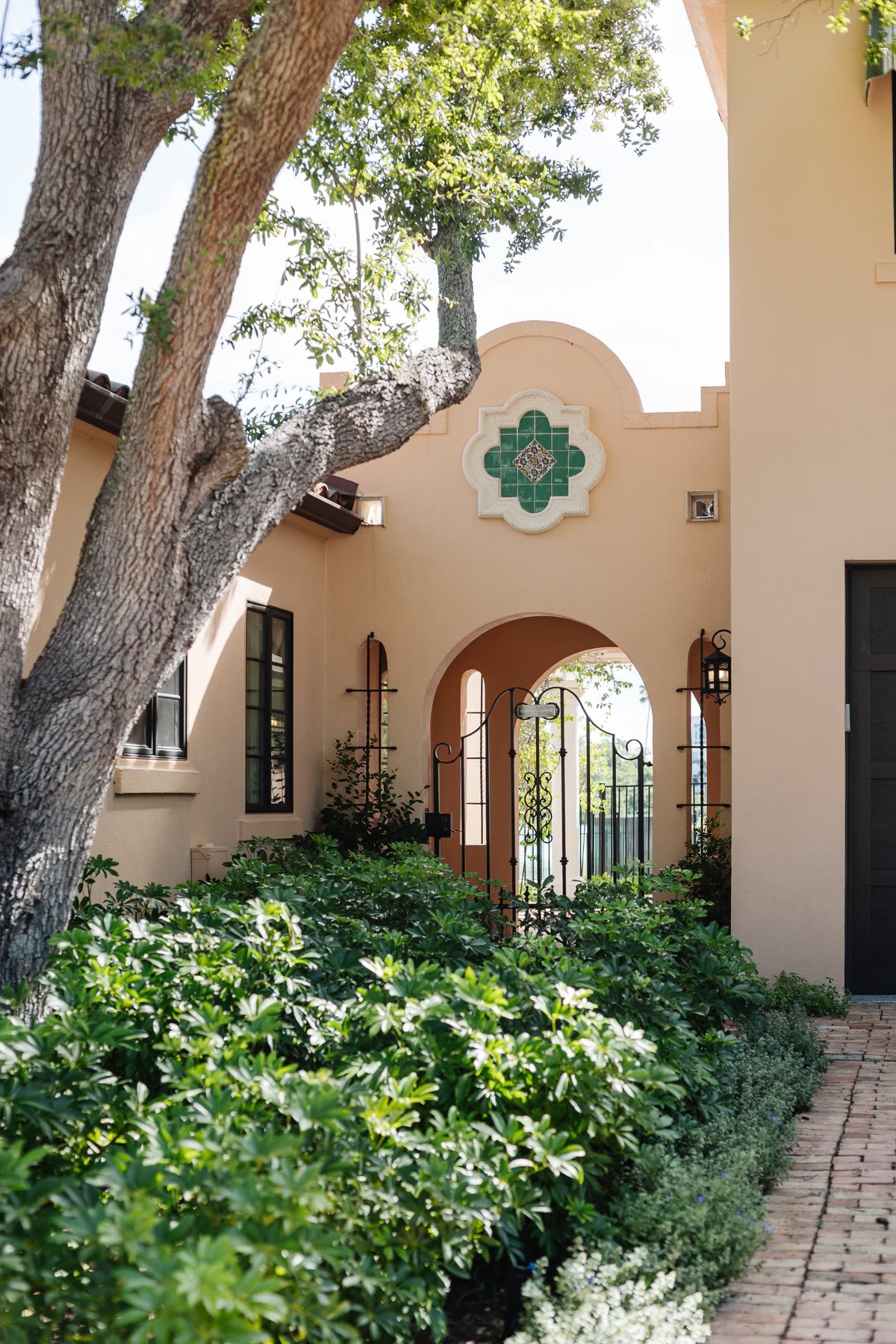 Courtyard gate with green quatrefoil tile and an arched passage